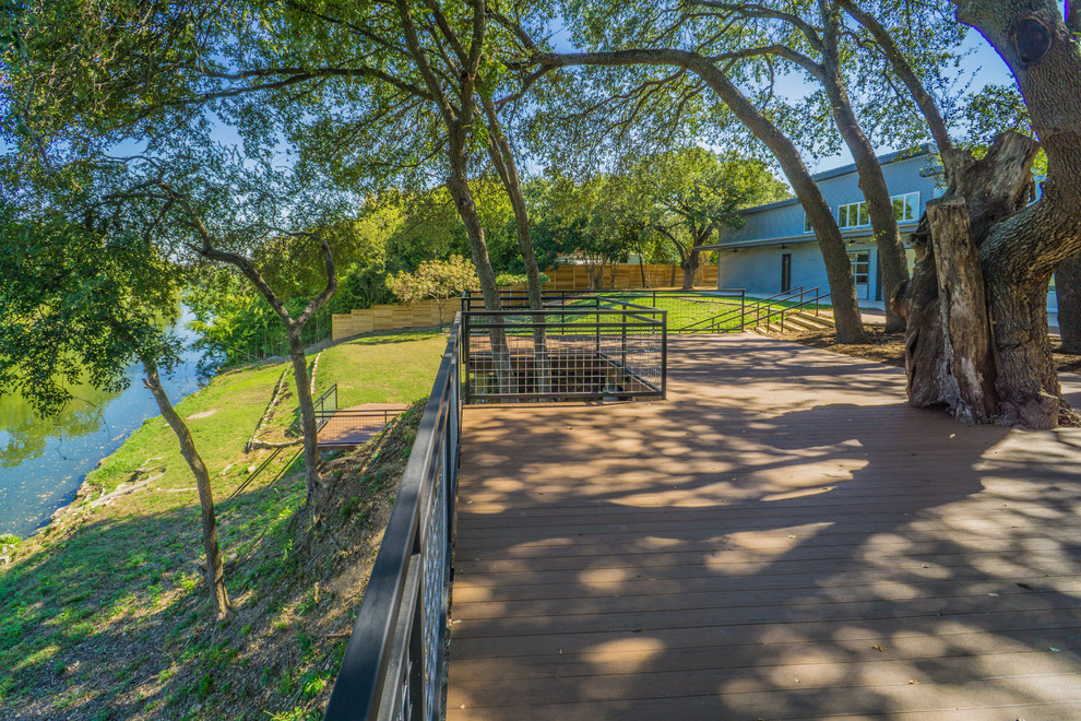 Huge 1950s backyard deck photo in Austin with an awning