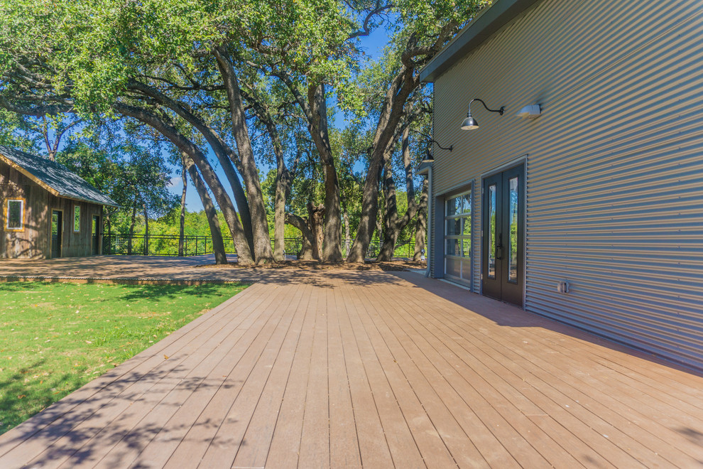 Photo of an expansive retro back terrace in Austin with an awning.