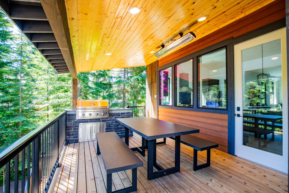 Photo of a medium sized modern back first floor metal railing terrace in Seattle with an outdoor kitchen and a roof extension.