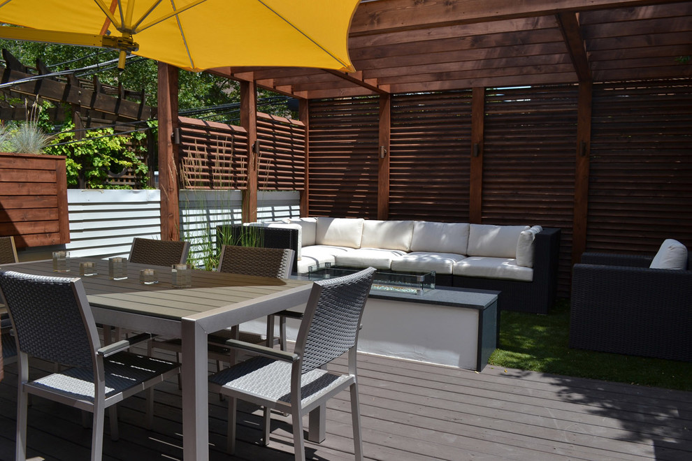 Example of a small transitional rooftop deck design in Chicago with a fire pit and a pergola
