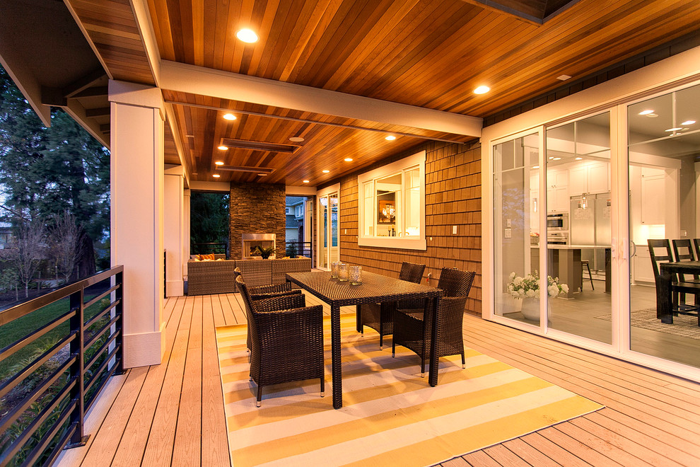 Inspiration for a huge transitional side yard deck remodel in Seattle with a roof extension