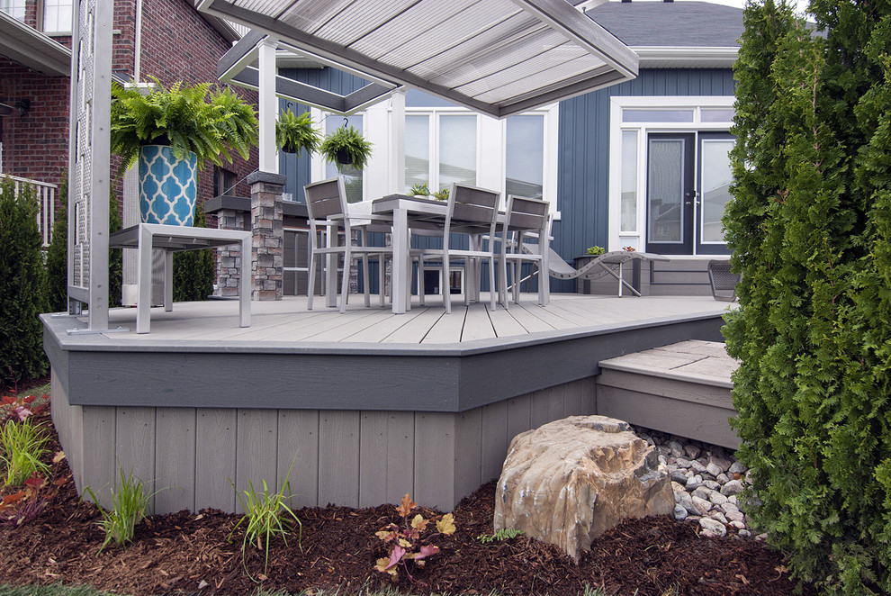 This is an example of a medium sized urban back terrace in Toronto with a fire feature and a pergola.