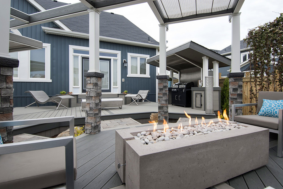 Inspiration for a medium sized urban back terrace in Toronto with a fire feature and a pergola.