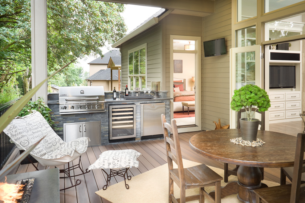 Example of a mid-sized classic backyard deck design in Vancouver with a fire pit and a roof extension
