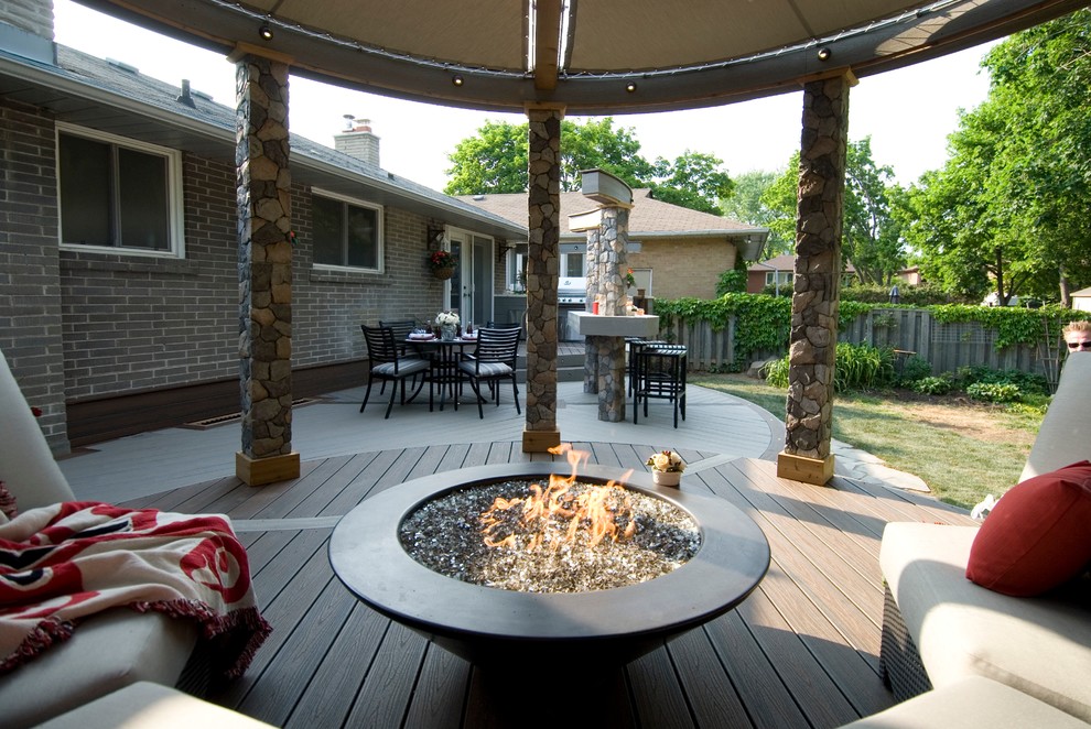 Mid-sized trendy backyard deck photo in Toronto with a fire pit