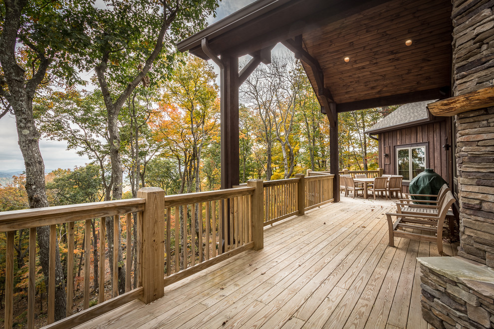 Photo of a large rustic side terrace in Charlotte with a fire feature and no cover.