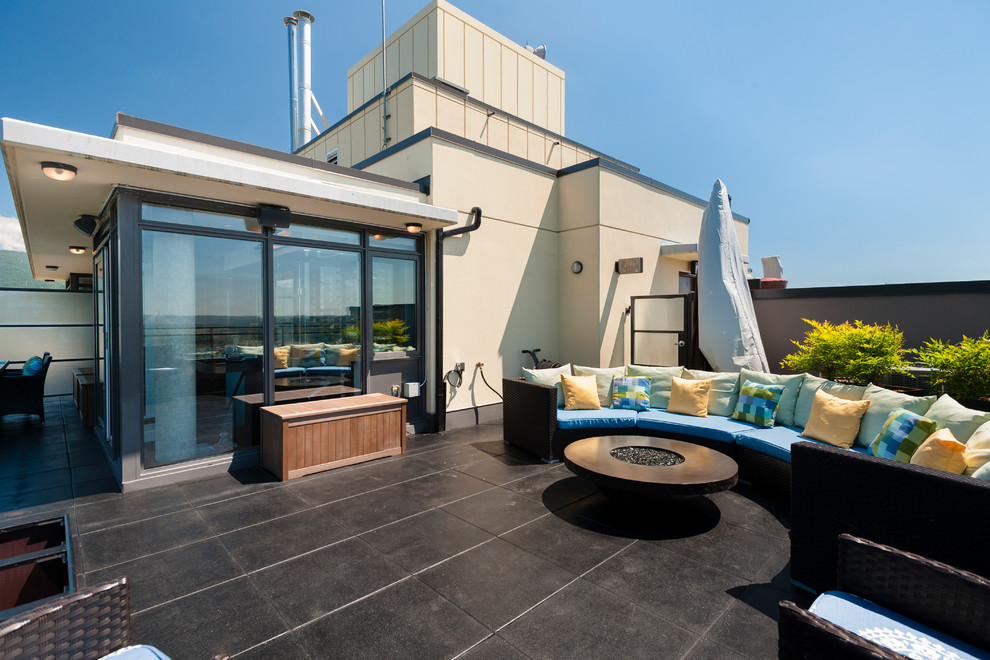 Deck - large transitional rooftop deck idea in Vancouver with a fire pit and no cover