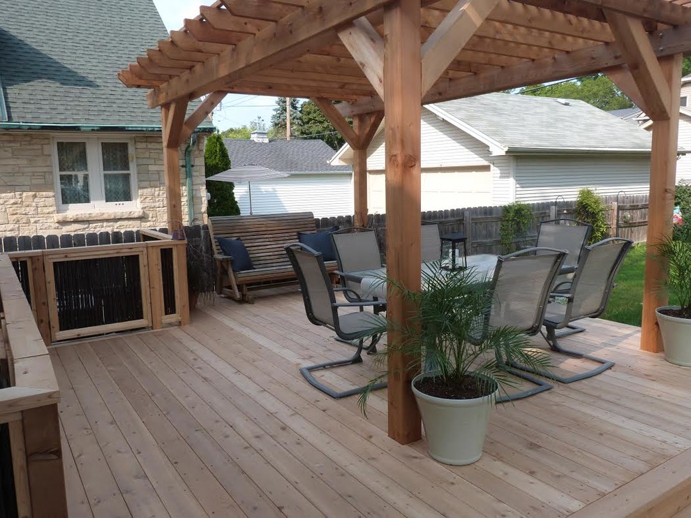 Mid-sized transitional backyard deck photo in Milwaukee with a pergola
