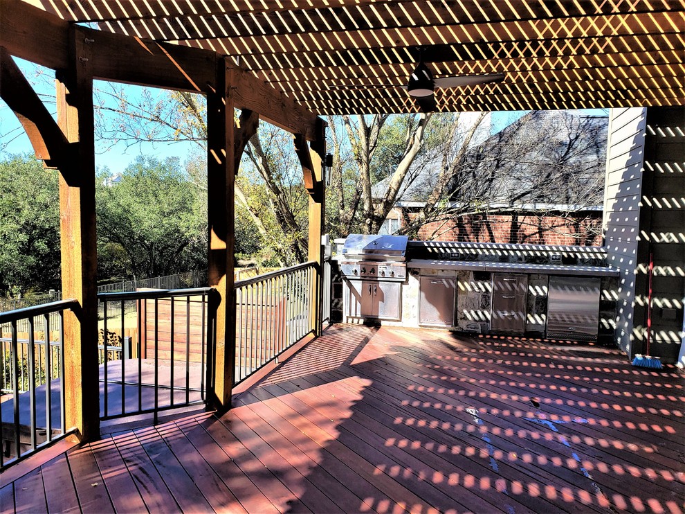 Outdoor kitchen deck - huge eclectic backyard outdoor kitchen deck idea in Austin with a pergola