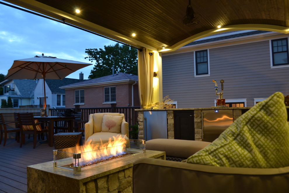 Deck - mid-sized traditional rooftop deck idea in Chicago with a fire pit and a roof extension
