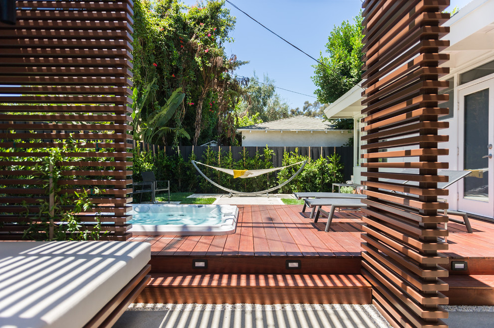 This is an example of a small contemporary back terrace in Los Angeles with a pergola.