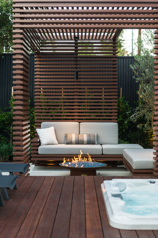 Inspiration for a small contemporary back terrace in Los Angeles with a fire feature and a pergola.