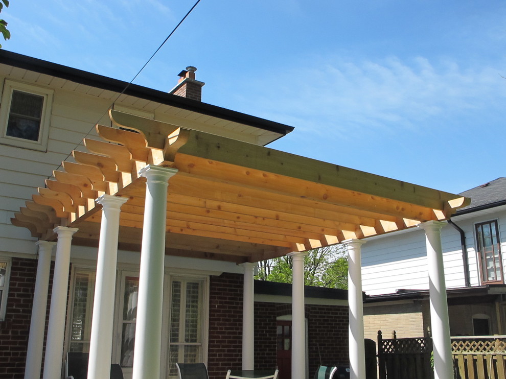 Photo of a medium sized mediterranean back terrace in Toronto with a pergola.