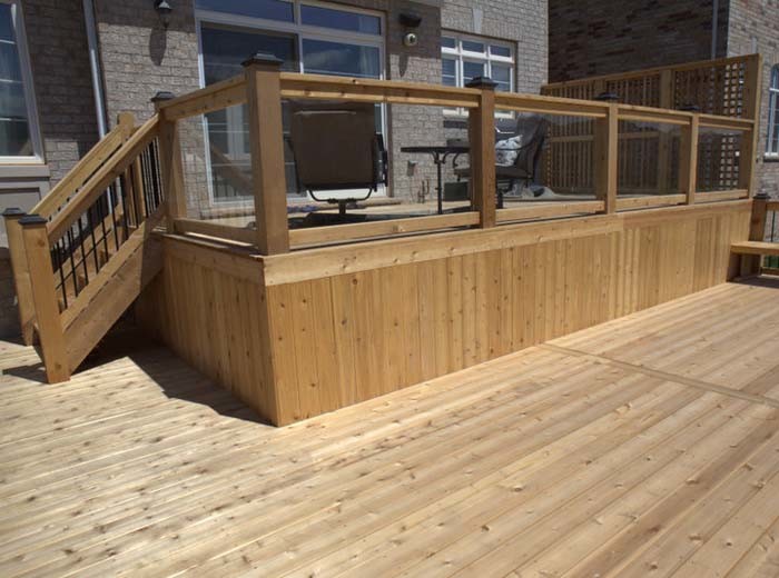 Two level custom deck with glass, heavy duty lattice and metal pickets