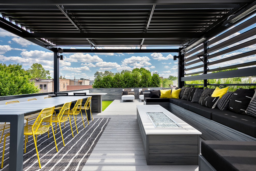 Expansive modern roof terrace in Chicago with a fire feature and a pergola.
