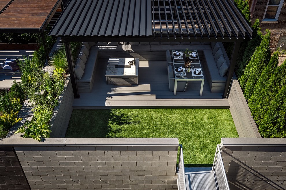 This is an example of a medium sized modern roof terrace in Chicago with a fire feature and a pergola.