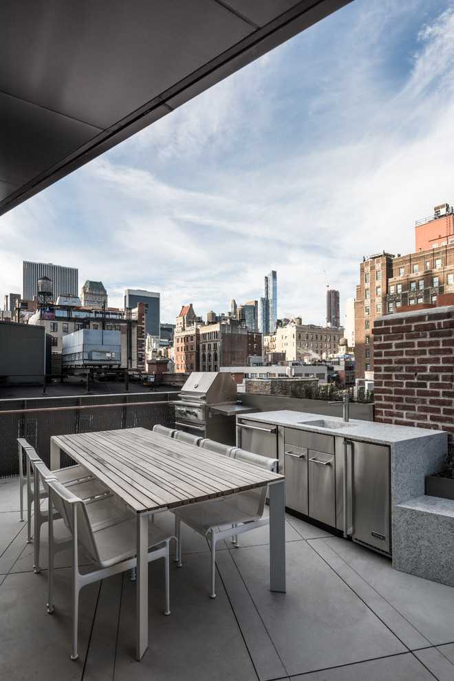 Design ideas for a contemporary terrace in New York with an outdoor kitchen and a roof extension.