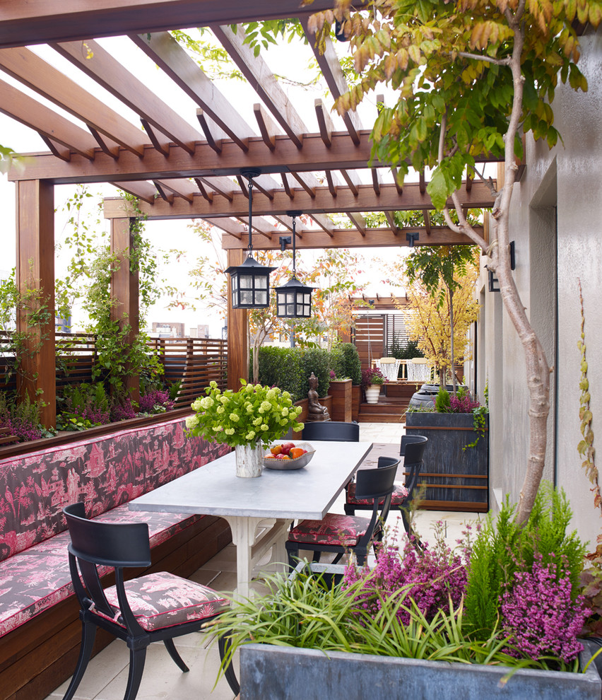 Inspiration for a contemporary roof rooftop terrace in New York with a pergola and fencing.
