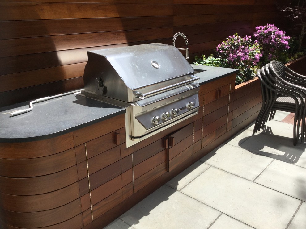 Photo of a medium sized contemporary roof terrace in New York with no cover and an outdoor kitchen.