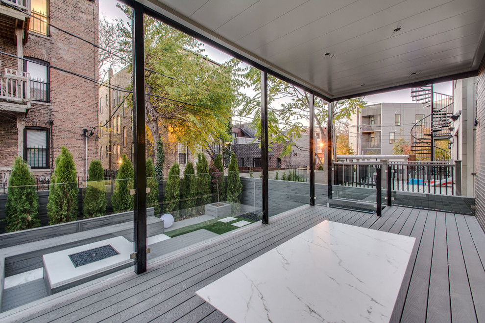Photo of a large modern back terrace in Chicago with a fire feature and no cover.