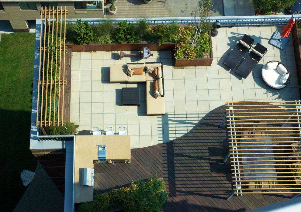 Design ideas for a contemporary roof terrace in New York with a pergola and a bbq area.