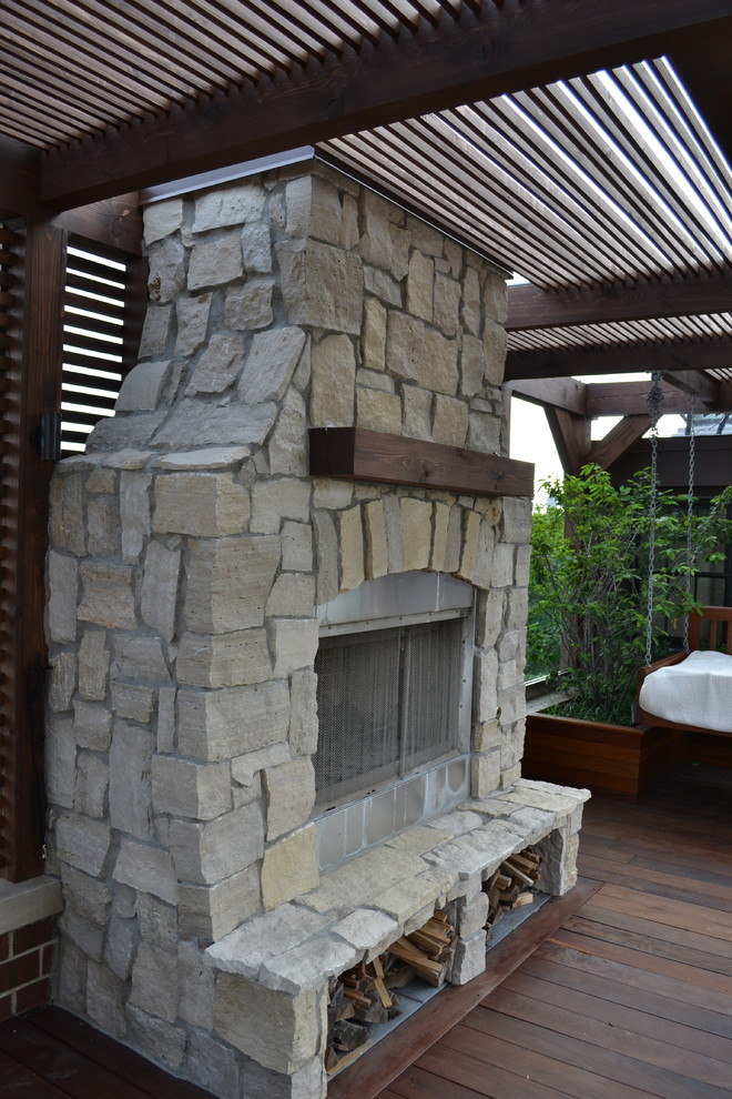 Photo of a large contemporary roof terrace in Chicago with a fire feature and a pergola.