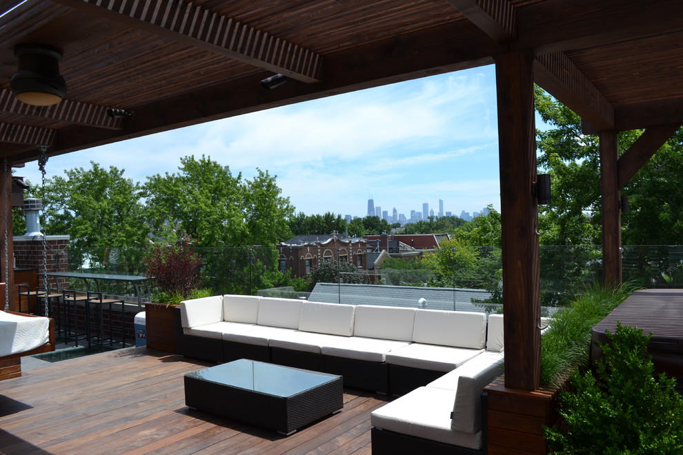 Example of a large trendy rooftop deck design in Chicago with a fire pit and a pergola