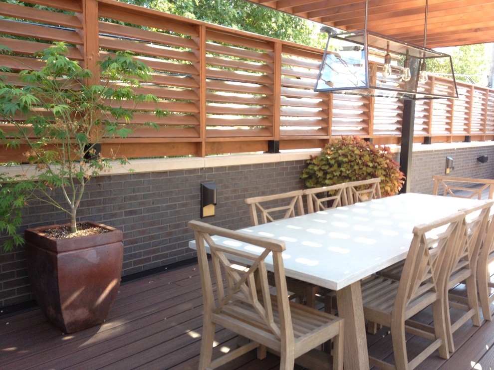 This is an example of a medium sized contemporary back terrace in Chicago with a pergola.