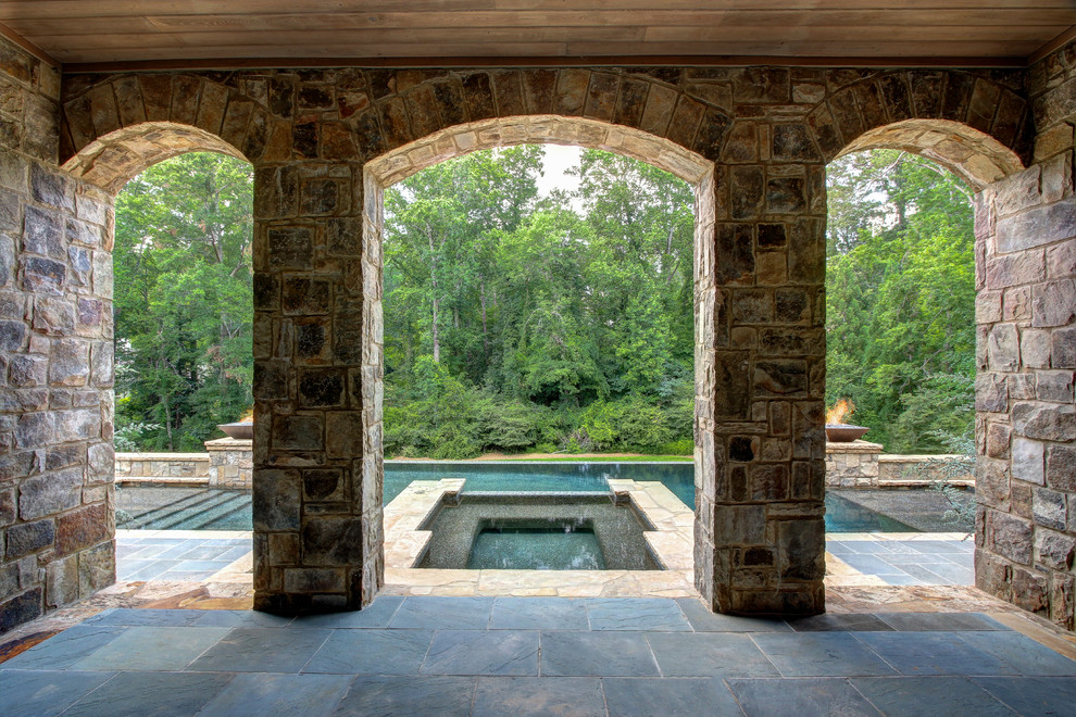 Photo of a large traditional back terrace in Atlanta with a water feature.