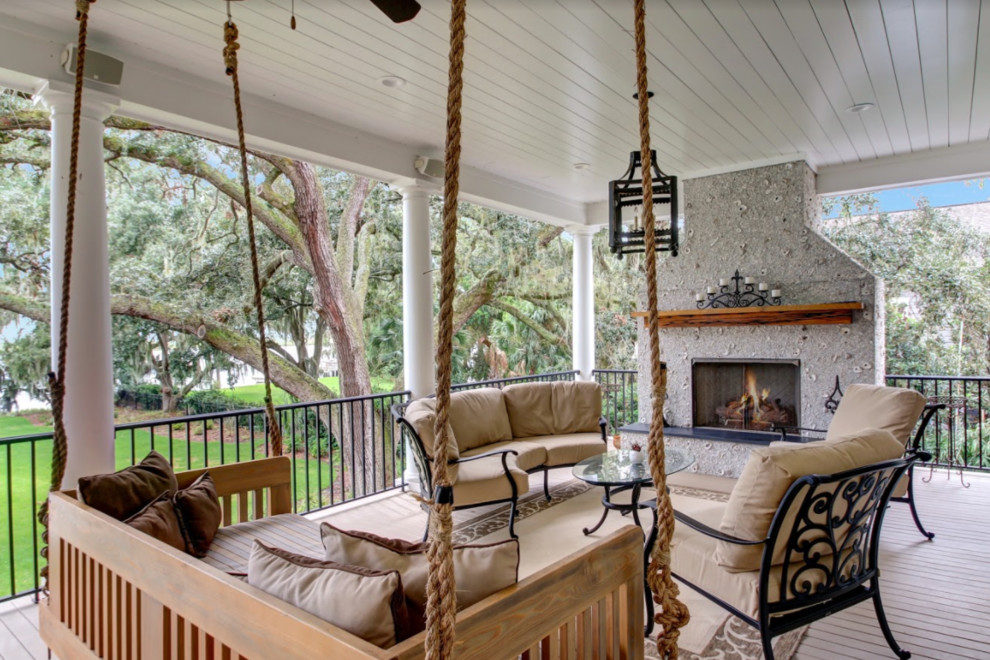 Inspiration for a mid-sized transitional backyard deck remodel in Atlanta with a fire pit and a roof extension