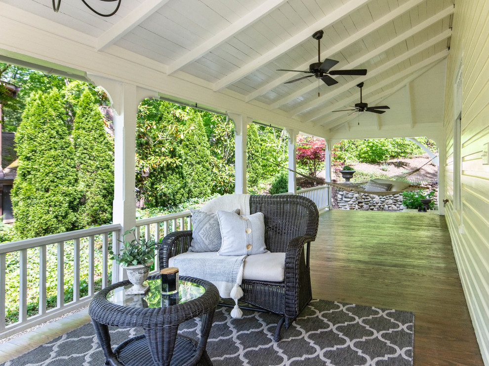 Deck - mid-sized country side yard deck idea in Other with a roof extension