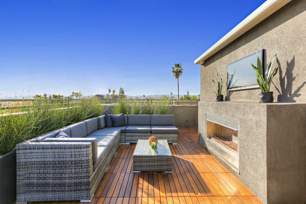 Inspiration for a contemporary rooftop rooftop deck remodel in Los Angeles with a fire pit and no cover