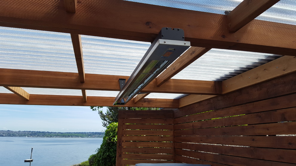 This is an example of a small coastal back terrace in Seattle with an awning.