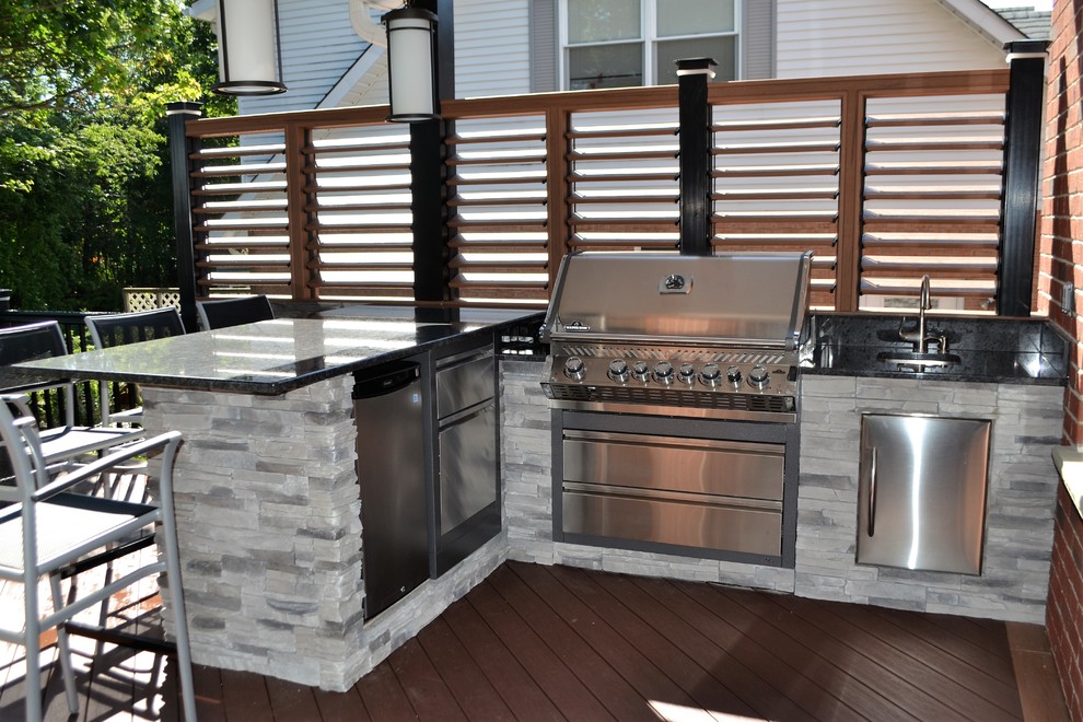 Inspiration pour une terrasse arrière design de taille moyenne avec une cuisine d'été et une extension de toiture.