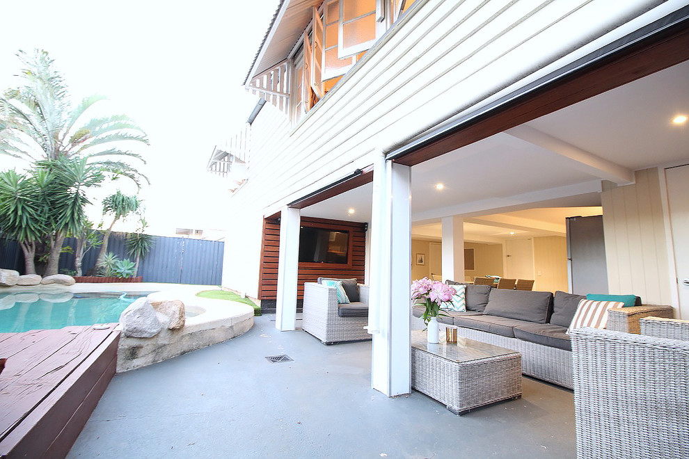Example of a trendy deck design in Brisbane with a roof extension
