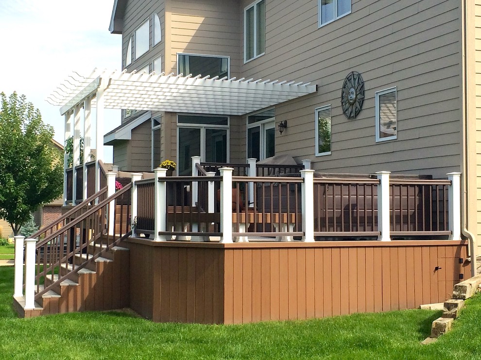 Example of a mid-sized classic backyard deck design in Other with a pergola