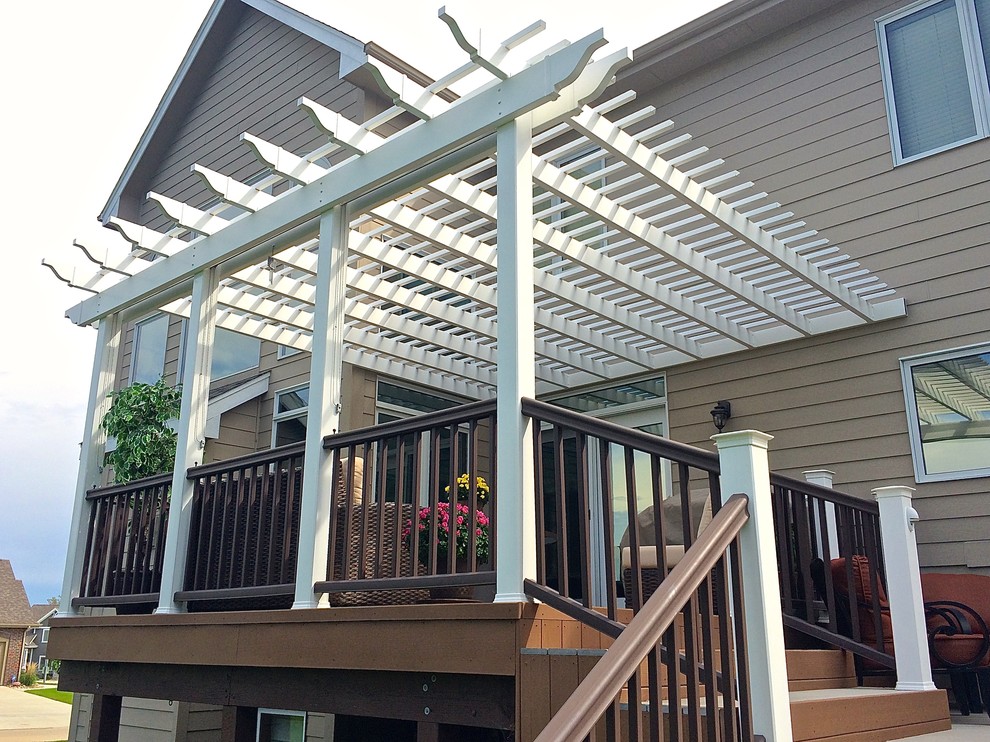 Example of a mid-sized classic side yard deck design in Other with a pergola