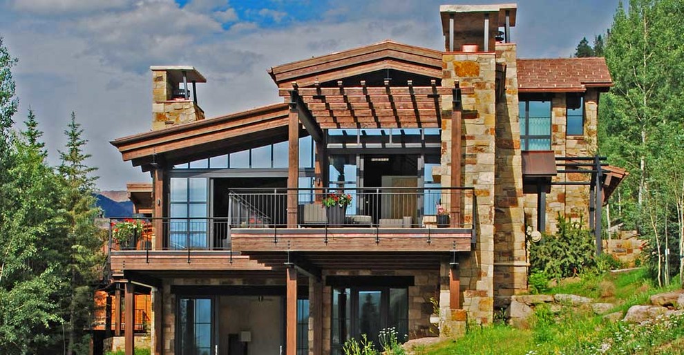 Inspiration for a large modern deck remodel in Denver with a pergola