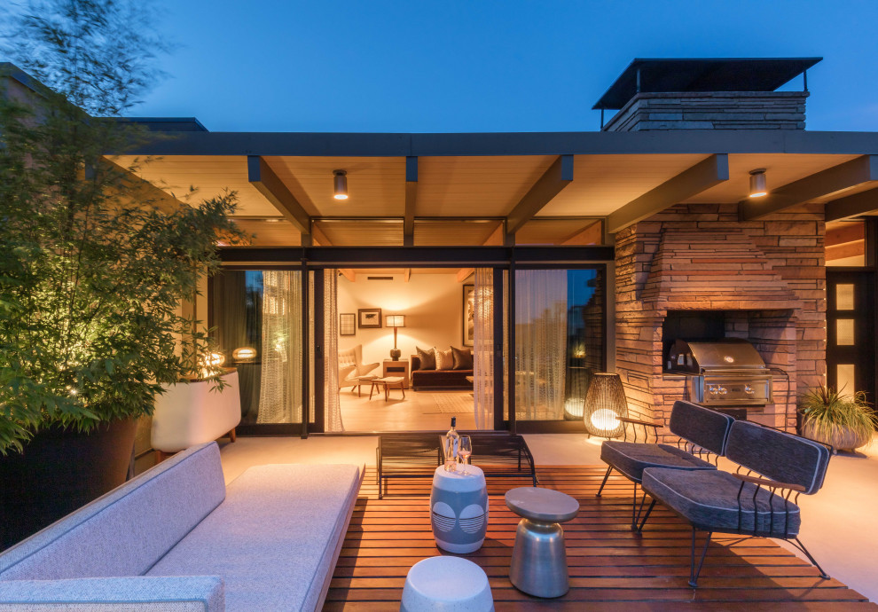 Inspiration pour une terrasse vintage avec une extension de toiture.
