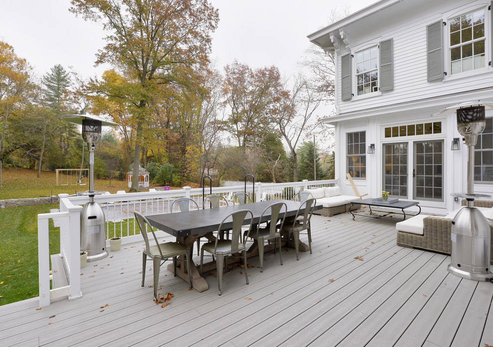 Example of a large ornate backyard deck design in New York with no cover