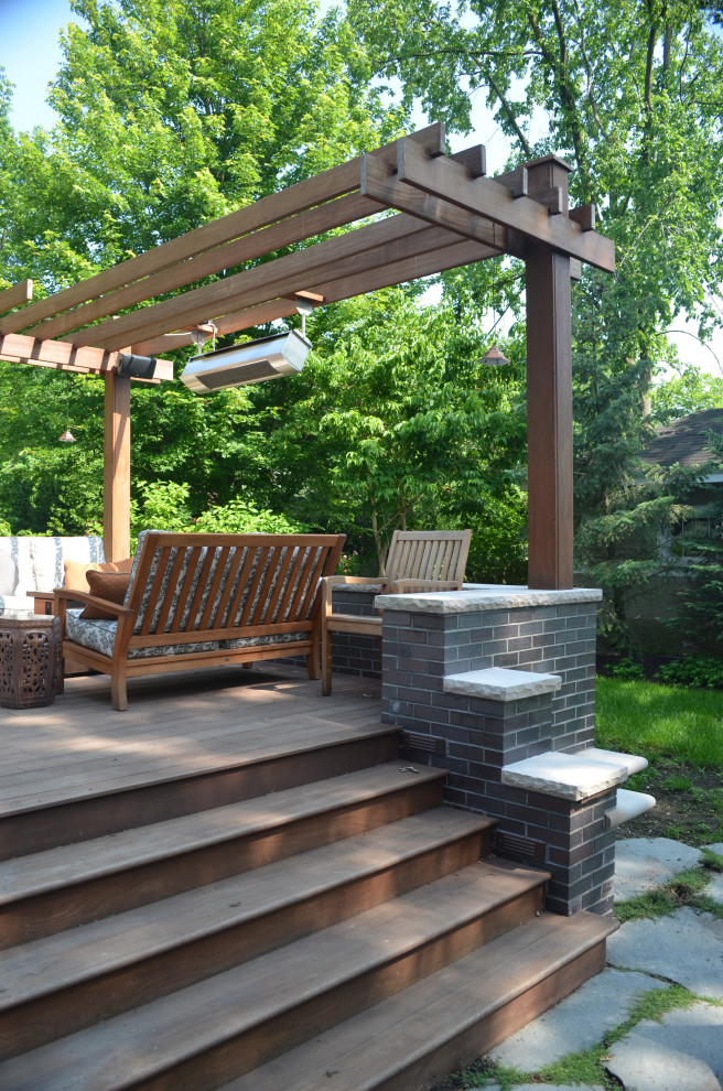 Imagen de terraza tradicional renovada de tamaño medio en patio trasero con brasero y pérgola