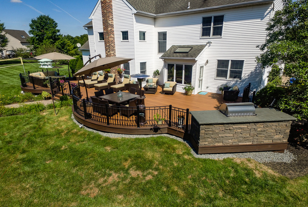 Deck - large traditional backyard deck idea in New York with a fire pit and no cover