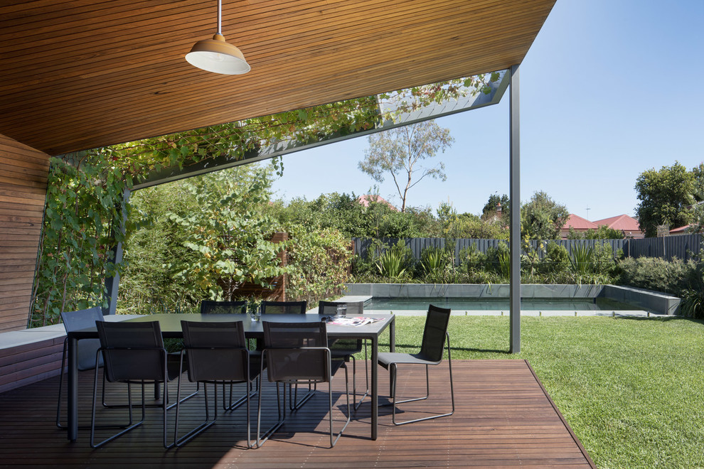 This is an example of a medium sized contemporary back terrace in Melbourne with an outdoor kitchen and a roof extension.