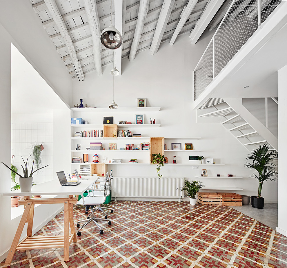 This is an example of a large scandi study in Barcelona with white walls, ceramic flooring, no fireplace and a built-in desk.