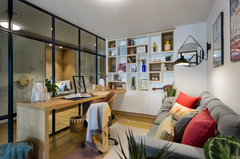 Imagen de despacho actual con paredes blancas, suelo de madera en tonos medios, escritorio empotrado y suelo marrón