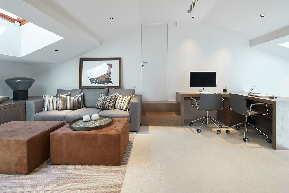 Photo of a contemporary home office in Barcelona with white walls, a freestanding desk and beige floors.