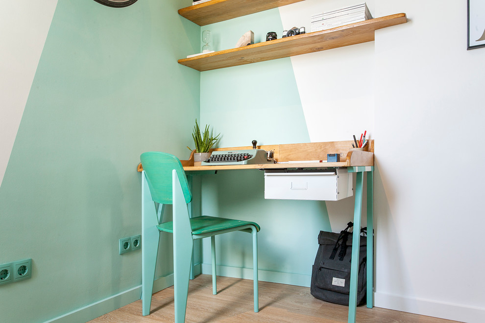 Inspiration for a small 1950s built-in desk light wood floor and brown floor home studio remodel in Barcelona with green walls