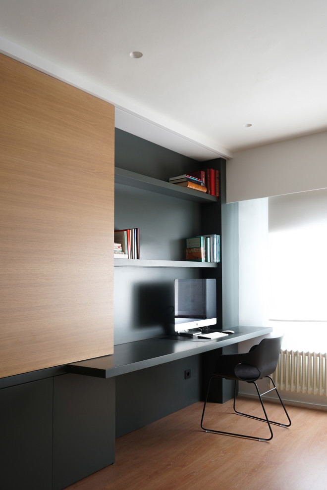 Mittelgroßes Modernes Arbeitszimmer mit braunem Holzboden, Arbeitsplatz, schwarzer Wandfarbe und Einbau-Schreibtisch in Valencia