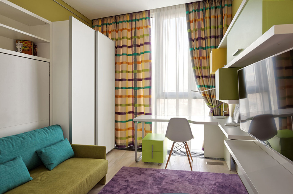 Inspiration pour une chambre d'enfant design de taille moyenne avec un bureau, un mur vert et parquet clair.