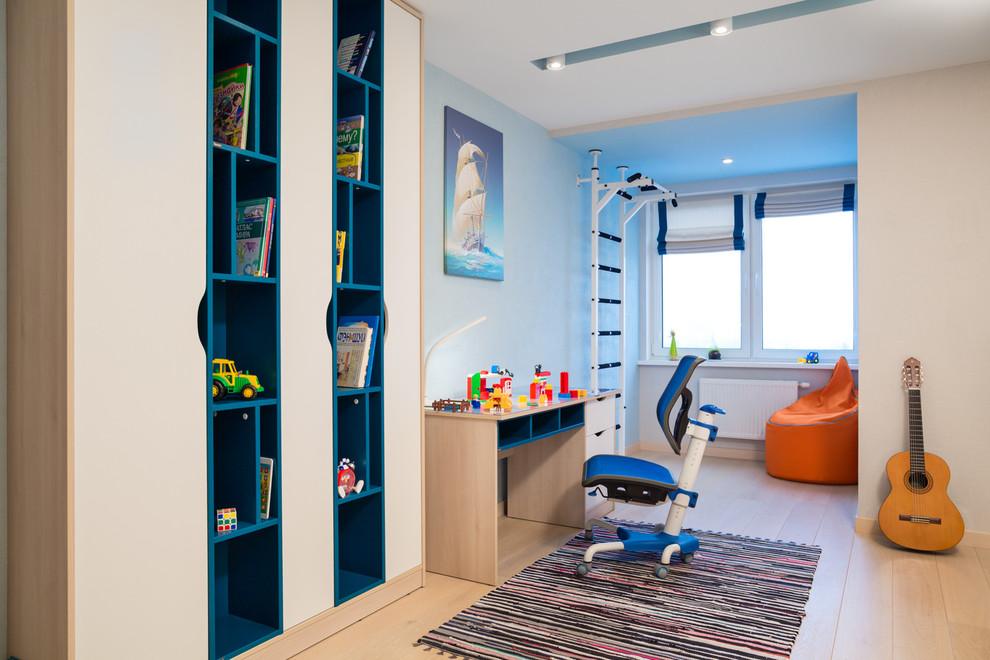Contemporary kids' bedroom for boys in Other with light hardwood flooring.